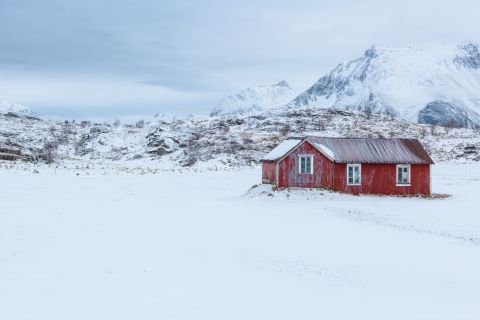Red cabin in snow landscape